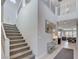 Carpeted staircase leading to the second floor with metal railing at 6 Lilla Rosa St, Henderson, NV 89011