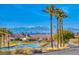 Picturesque street view with palm trees, a golf course, and a view of the city skyline and mountains at 6 Lilla Rosa St, Henderson, NV 89011