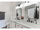 Modern bathroom with double vanity, quartz countertop, and large mirrors at 601 Harvest Run Dr # 201, Las Vegas, NV 89145