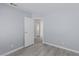 Simple bedroom with light gray walls and wood-look floors at 6200 Budnick Cir, Las Vegas, NV 89130