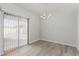 Bright dining room features modern chandelier and sliding door to backyard at 6200 Budnick Cir, Las Vegas, NV 89130