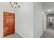 Bright entryway with wood door and chandelier leading to the living area at 6200 Budnick Cir, Las Vegas, NV 89130