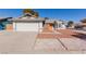 One-story house with a two-car garage and landscaped front yard at 6200 Budnick Cir, Las Vegas, NV 89130