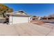 House exterior highlighting a two-car garage and small front yard at 6200 Budnick Cir, Las Vegas, NV 89130