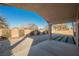 Covered patio overlooking a gravel backyard with a small landscaped area at 6304 Tanzanite Ave, Las Vegas, NV 89130