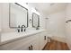 Modern bathroom with double vanity, white cabinets, and black matte fixtures at 6304 Tanzanite Ave, Las Vegas, NV 89130