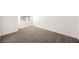 The empty bedroom has neutral carpet, base trim and walls at 6304 Tanzanite Ave, Las Vegas, NV 89130