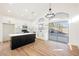 Modern kitchen with island, white cabinets, and access to backyard at 6304 Tanzanite Ave, Las Vegas, NV 89130