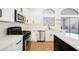 Modern kitchen with white cabinets, quartz counters, and stainless steel appliances at 6304 Tanzanite Ave, Las Vegas, NV 89130