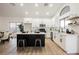 Bright kitchen with white cabinetry, island with bar stool seating, and modern stainless steel appliances at 6304 Tanzanite Ave, Las Vegas, NV 89130