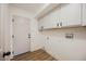 Bright laundry room features built-in cabinets and vinyl flooring at 6304 Tanzanite Ave, Las Vegas, NV 89130