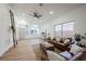 Cozy living room with leather couches, neutral rug, and ample natural light at 6304 Tanzanite Ave, Las Vegas, NV 89130