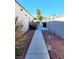 Side yard with a concrete pathway and desert landscaping at 637 Bay Bridge Dr, North Las Vegas, NV 89032