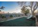 Landscaped backyard with artificial turf and lounge chair at 6513 Hyde Ave, Las Vegas, NV 89107