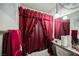 Bathroom with burgundy curtains, bathtub, and vanity at 6513 Hyde Ave, Las Vegas, NV 89107