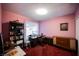 Pink bedroom with a desk, chair, and vintage stereo at 6513 Hyde Ave, Las Vegas, NV 89107