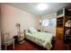 Charming bedroom with a full-size bed, window coverings, and a chair at 6513 Hyde Ave, Las Vegas, NV 89107