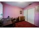 Pink bedroom with a desk, chair, and sliding door closet at 6513 Hyde Ave, Las Vegas, NV 89107