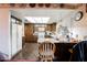 Kitchen with wood cabinets, white appliances, and a breakfast bar at 6513 Hyde Ave, Las Vegas, NV 89107