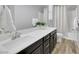 Modern bathroom with dark vanity, shower and bathtub at 6692 Radiant Red Ave, Las Vegas, NV 89130