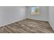 Light and airy bedroom with wood-look tile floors at 6692 Radiant Red Ave, Las Vegas, NV 89130