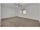 Bedroom with ceiling fan, neutral carpet, and a window providing natural light at 6692 Radiant Red Ave, Las Vegas, NV 89130