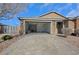 Front exterior featuring a two car garage and paver driveway at 6692 Radiant Red Ave, Las Vegas, NV 89130