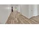 Light and airy hallway with wood-look tile flooring at 6692 Radiant Red Ave, Las Vegas, NV 89130