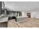 Modern kitchen with large island, dark cabinets, and granite countertops at 6692 Radiant Red Ave, Las Vegas, NV 89130