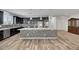 Open-concept kitchen with island and dark cabinetry at 6692 Radiant Red Ave, Las Vegas, NV 89130