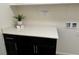 Bright laundry room with quartz countertop and dark cabinets at 6692 Radiant Red Ave, Las Vegas, NV 89130