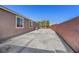 Large concrete patio area adjacent to the house with a block wall at 6692 Radiant Red Ave, Las Vegas, NV 89130