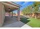 Covered patio with ceiling fans overlooking a spacious yard featuring lush artificial turf at 6692 Radiant Red Ave, Las Vegas, NV 89130