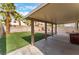 Backyard featuring artificial turf, a block fence, and a covered patio at 6712 Painted Canyon Ct, Las Vegas, NV 89130