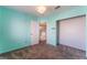 Carpeted bedroom featuring an open closet and adjacent view of the stairway at 6712 Painted Canyon Ct, Las Vegas, NV 89130