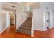 Entryway with carpeted stairs, wood floors, and arched doorway at 6712 Painted Canyon Ct, Las Vegas, NV 89130