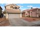 View of two-story home with beige exterior, tile roof, and concrete driveway at 6712 Painted Canyon Ct, Las Vegas, NV 89130