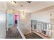 Hallway with stairway overlooking living area and view into nearby rooms at 6712 Painted Canyon Ct, Las Vegas, NV 89130