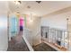 Hallway with stairway overlooking living area and view into nearby rooms at 6712 Painted Canyon Ct, Las Vegas, NV 89130