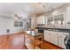 Eat in kitchen featuring modern appliances, an island, natural light and tile flooring at 6712 Painted Canyon Ct, Las Vegas, NV 89130