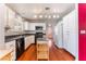 Well-lit kitchen with stainless steel microwave, white cabinets, and dark countertops at 6712 Painted Canyon Ct, Las Vegas, NV 89130