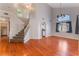 Open concept living room featuring hardwood floors, high ceilings and staircase at 6712 Painted Canyon Ct, Las Vegas, NV 89130