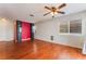 Spacious living room with hardwood floors, large windows, and modern ceiling fan at 6712 Painted Canyon Ct, Las Vegas, NV 89130