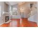 Living room with high ceilings, fireplace, and wood floors, leading to stairs at 6712 Painted Canyon Ct, Las Vegas, NV 89130