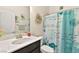 Clean bathroom with a marble countertop, teal shower curtain, and nautical decor at 685 Sea Star St, Henderson, NV 89002