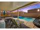 Covered patio with comfortable seating overlooking the pool at 685 Sea Star St, Henderson, NV 89002