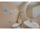 Clean and updated powder room with white vanity and oval mirror at 7182 Hood River Ave, Las Vegas, NV 89179