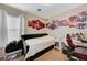 Bedroom with twin bed, desk, and anime wall art at 7182 Hood River Ave, Las Vegas, NV 89179