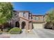 Two story house with beige exterior, attached garage, and landscaping at 7182 Hood River Ave, Las Vegas, NV 89179