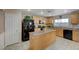 Kitchen with island, wood cabinets, and black appliances at 7182 Hood River Ave, Las Vegas, NV 89179